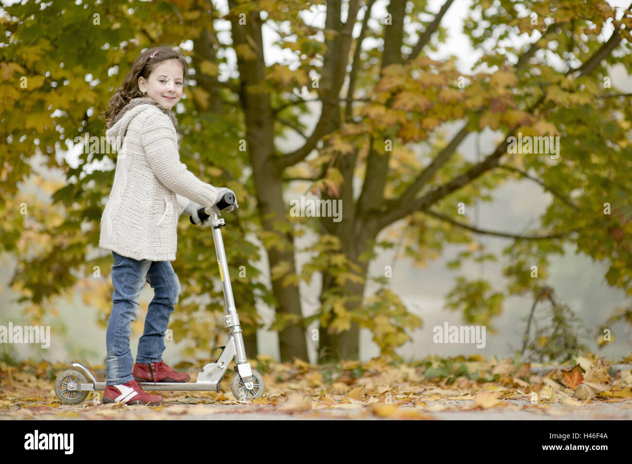 Little girl on a scooter Stock Photo Alamy