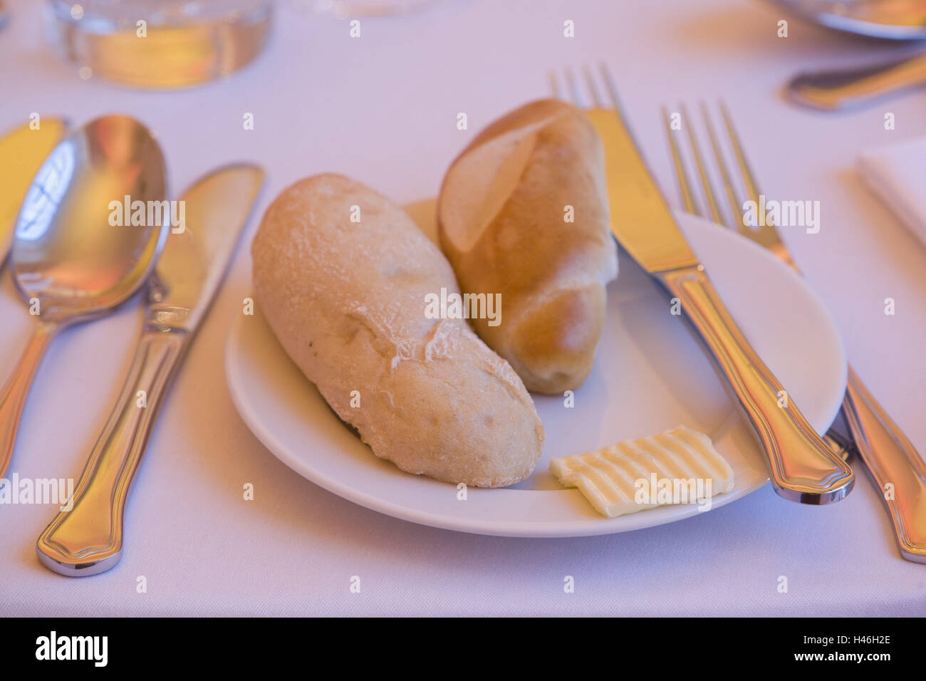 Table set, cutlery, bread roll, butter Stock Photo Alamy