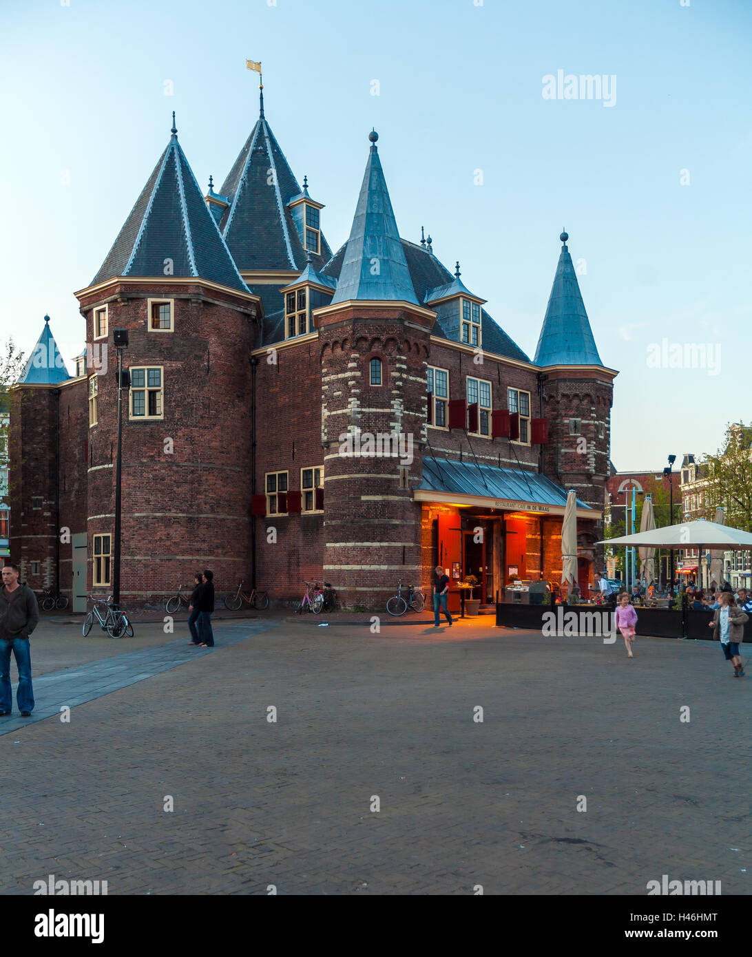 AMSTERDAM, NETHERLANDS - APRIL 4, 2008: Tourists eat at a cafe in the building of The Waag (weigh house) on Nieuwmarkt square Stock Photo