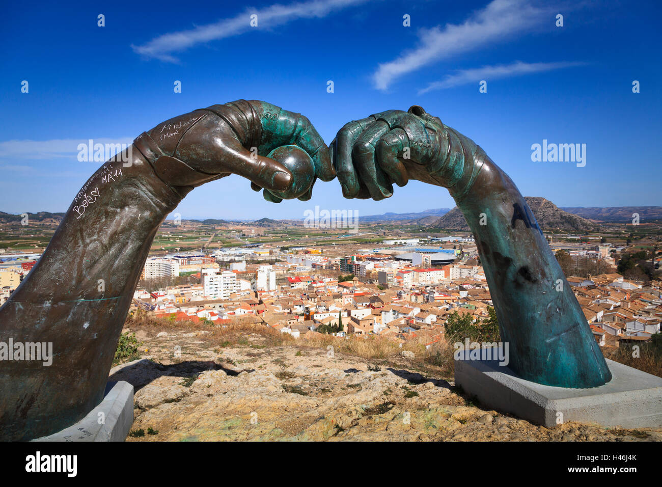Pelota sculpture of two hands with ball above the city of Xativa in Spain Stock Photo