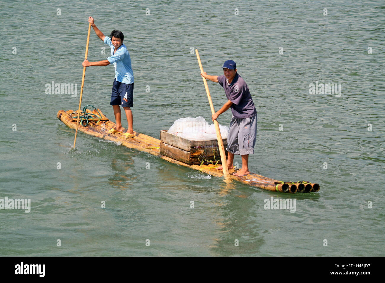 China, Li river, two men on a raft, Stock Photo