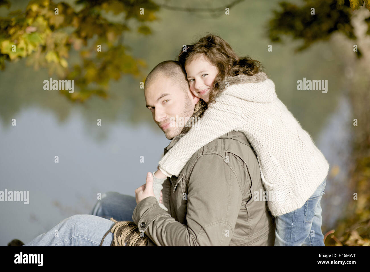 Subsidiary snuggles up to father, Stock Photo