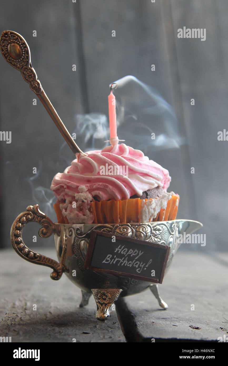Delicious birthday cupcake with single candle and spoon Stock Photo Alamy