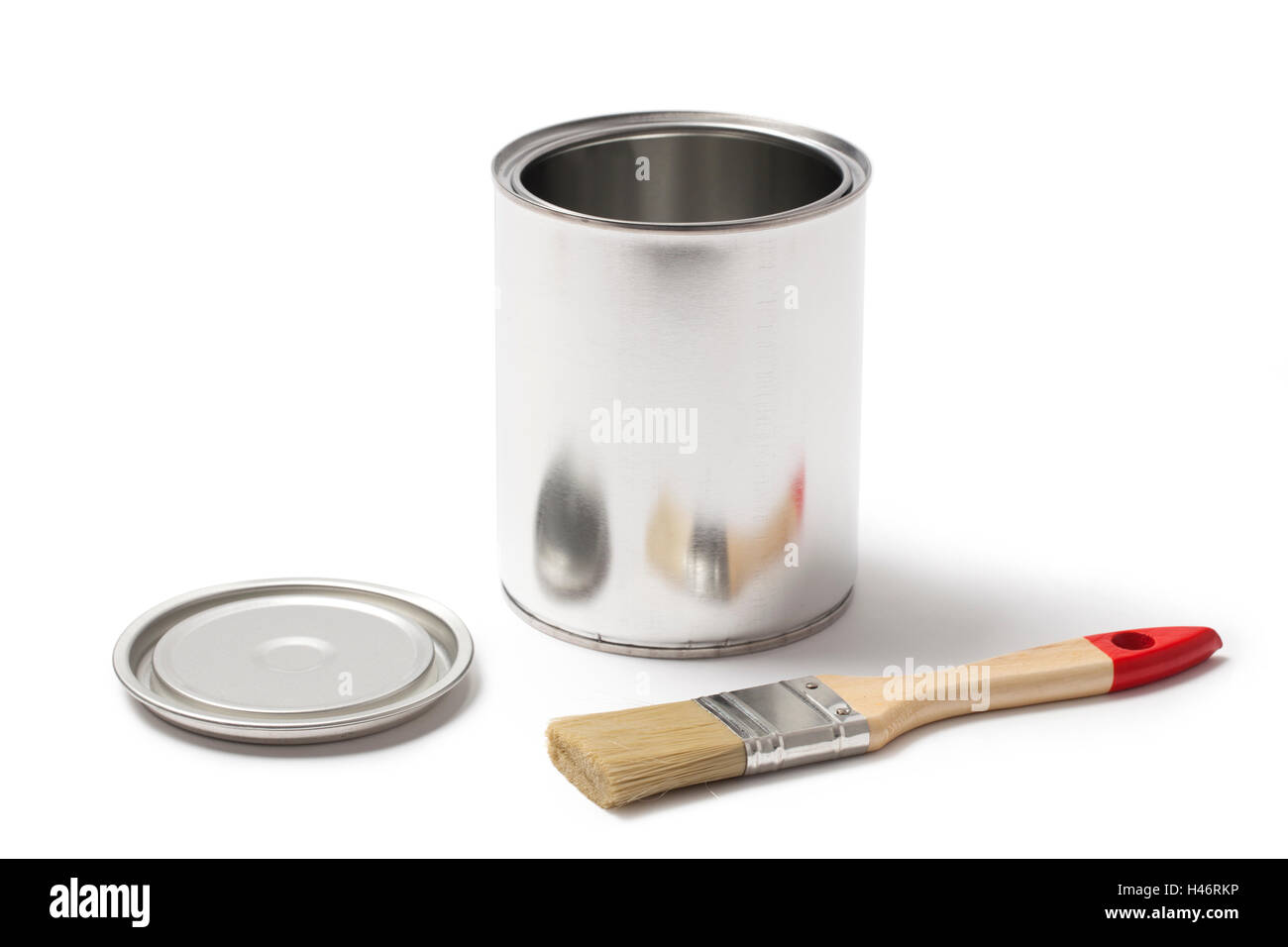 Blank metallic can for paint with an open lid and a paint brush isolated on white background. Stock Photo