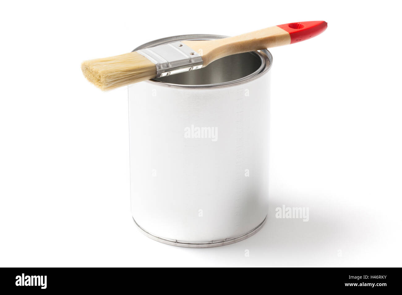 Open blank metallic can for paint with a paint brush put on it isolated on white background. Stock Photo