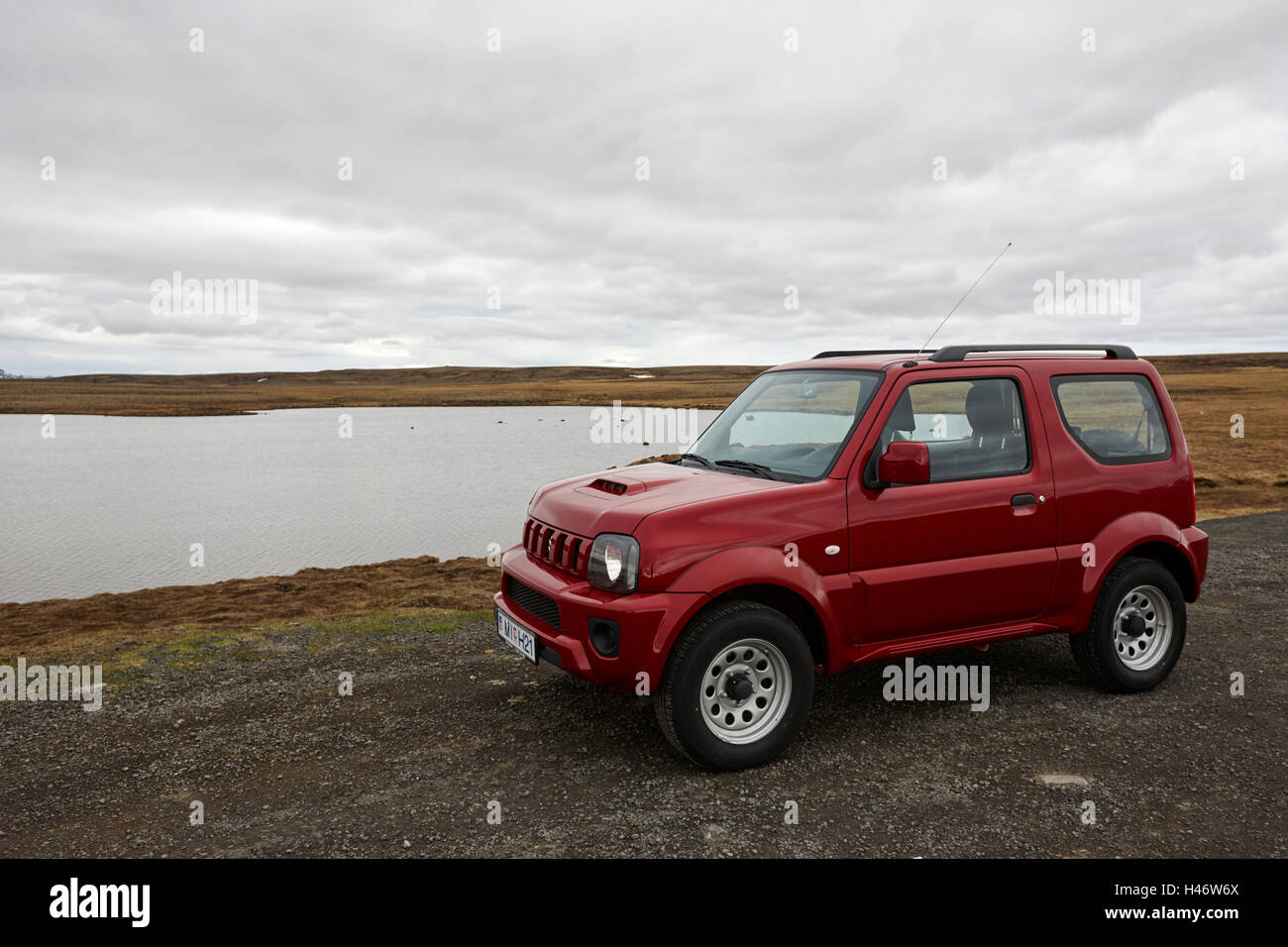 Suzuki jimny 4x4 off road hire car by a lake in thingvellir Iceland Stock Photo