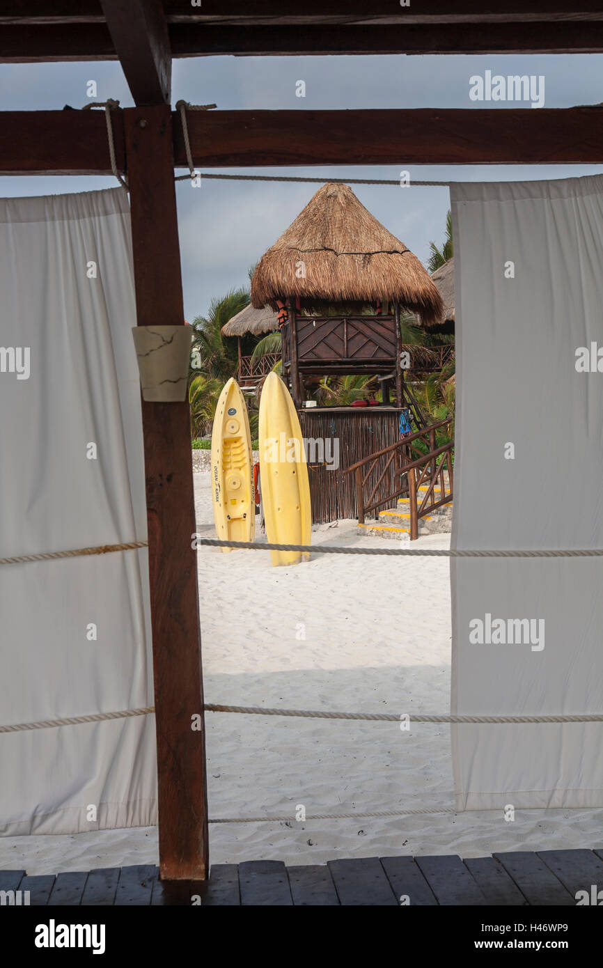 Beach Tiki Hut with Yellow Kayaks Stock Photo