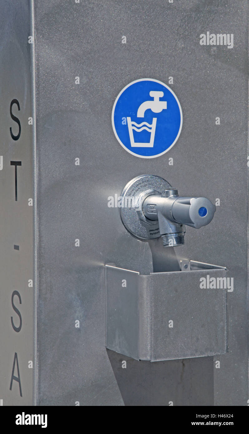 Drinking water pillar with icon and tap, Stock Photo