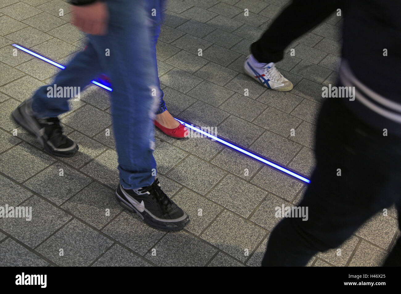 several people run in parallel with neon light, detail, feet Stock ...