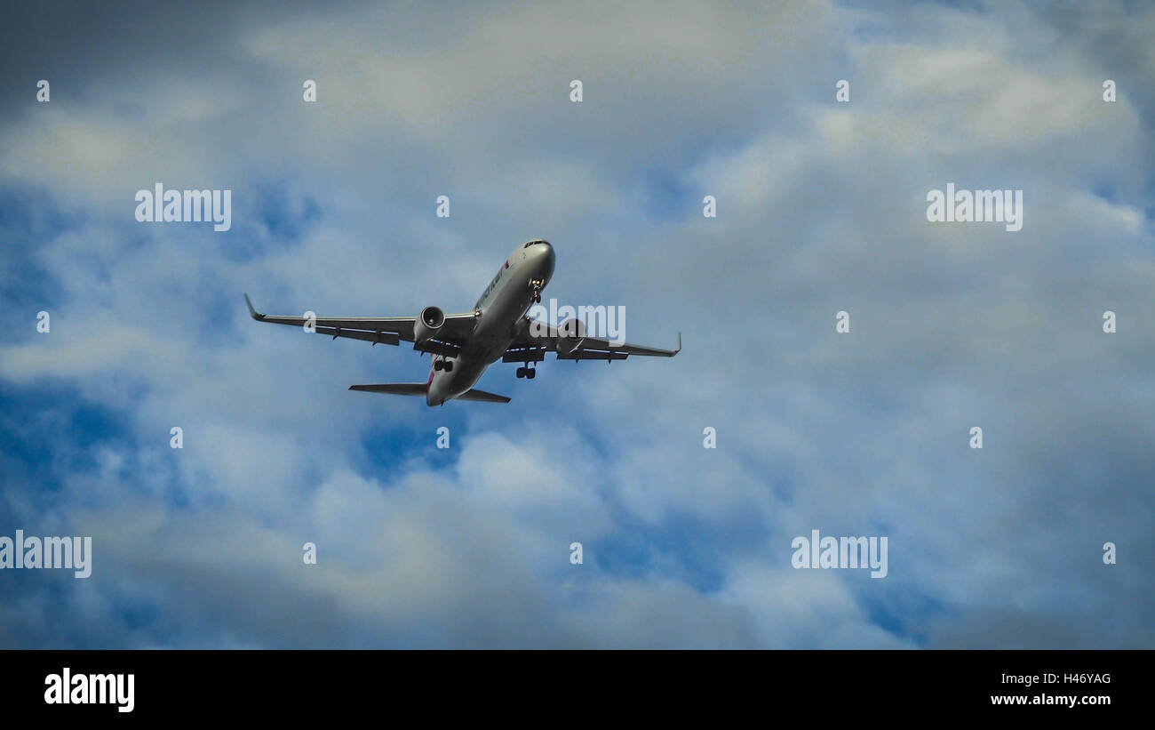 Airplane in the blue sky Stock Photo - Alamy