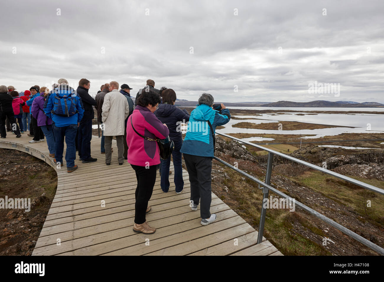 tourists take photos overlooking thingvellir lake Iceland Stock Photo