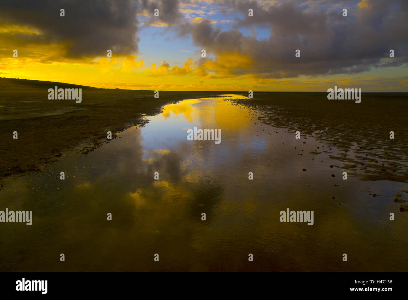 Sunset reflected in channel on vast area of Holkham Beach and bay a National Nature Reserve in Norfolk Stock Photo