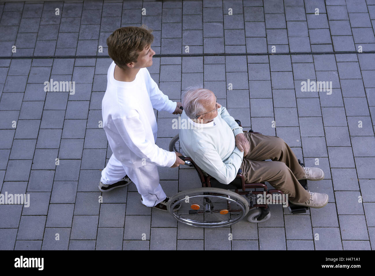 Town, geriatric nurse, boss, invalid's wheel chair, push, from above, Stock Photo