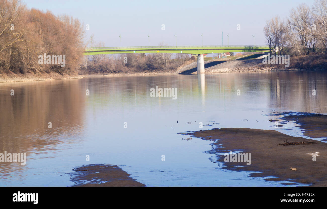 Riverside, and a bridge in the distance Stock Photo - Alamy