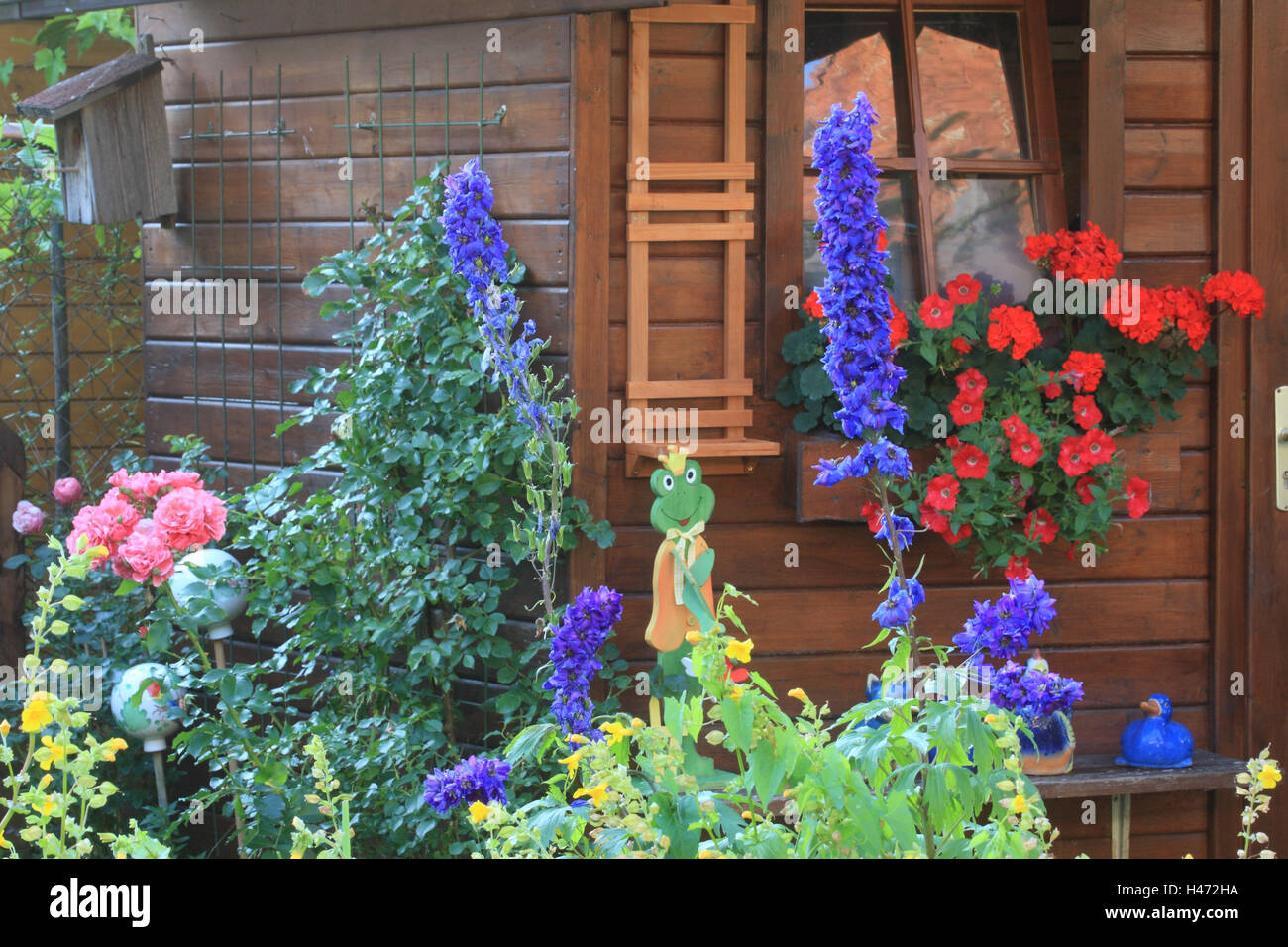 Summer house with flowers and figures in summer Stock Photo - Alamy