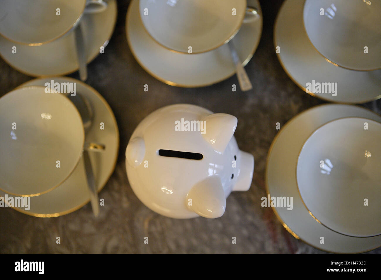 Cups, piggy bank, porcelain pig, white, dishes, unterplate, porcelain, golden margin, spoon, money, save, finances, 'bank', value, investment, invest, euro, icon, future, economy piglet, currency, financial market, economically, slot, 'economy', thrift, m Stock Photo