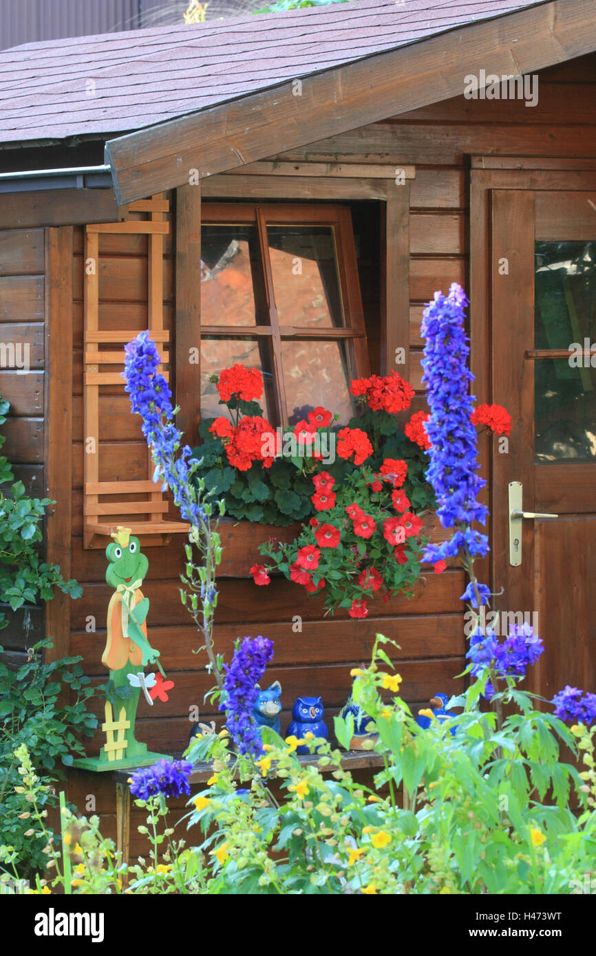 Summer house with flowers and figures in summer Stock Photo - Alamy