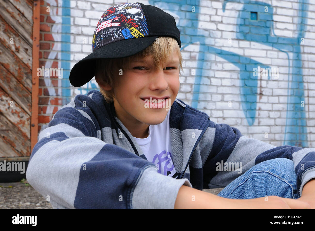Boy skaters baseball cap sit view camera portrait kids