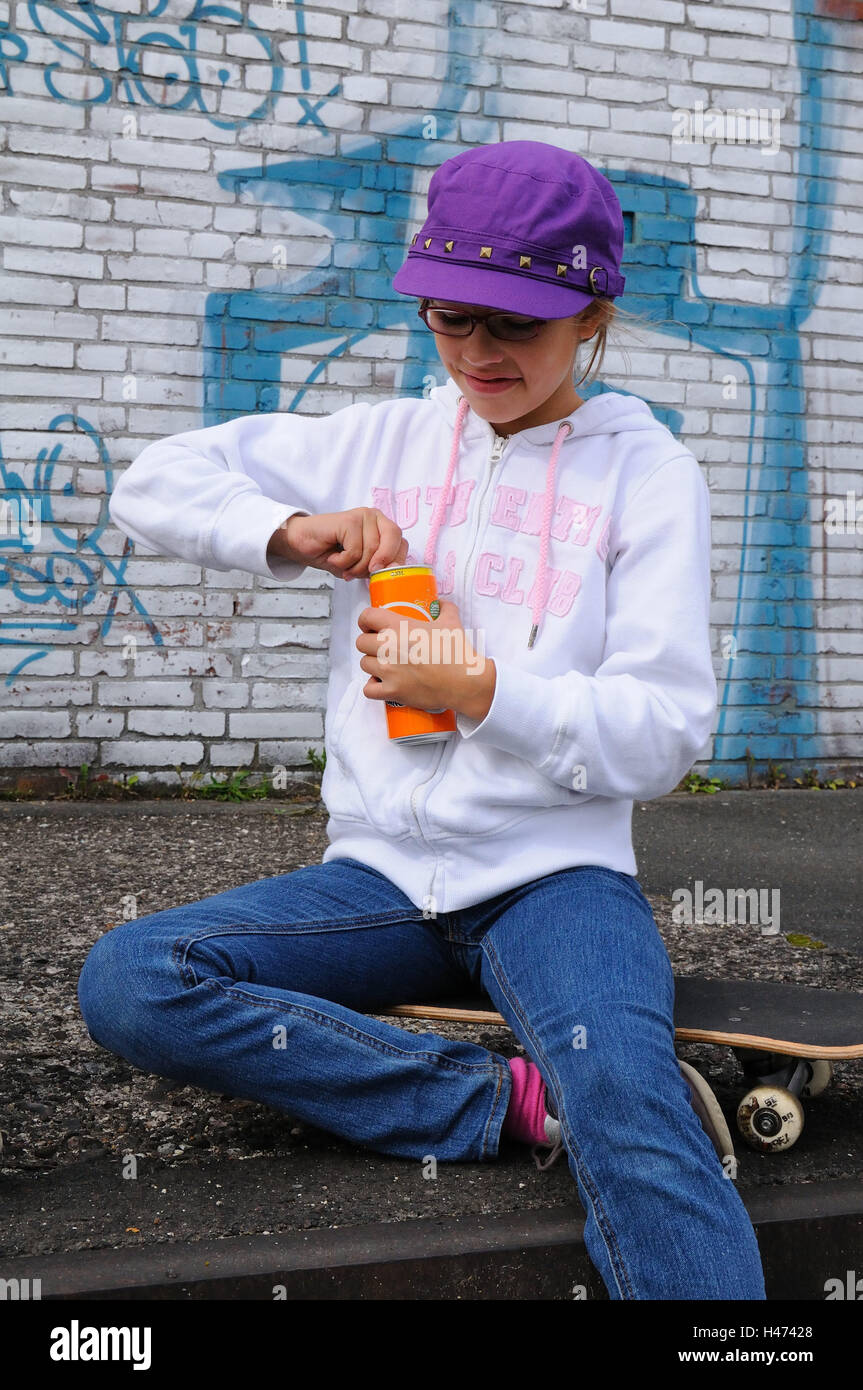 Girls, mauve cap, glasses, drinks can, open, skateboard, sit, kids, young persons, playing skat, skaters, cap, break, happy, lighthearted, childhood, youth, cap, outfit, youth culture, industrial scales, leisure time, outside, business park, graffiti, jea Stock Photo
