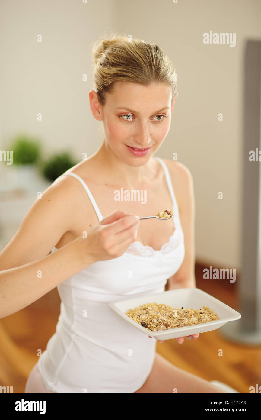 Young woman eats muesli, Stock Photo