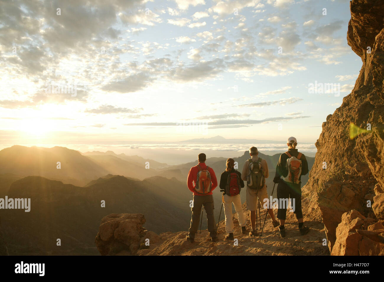 Traveling-group, standing, back view, rocks, pause, mountain scenery, evening-mood Stock Photo