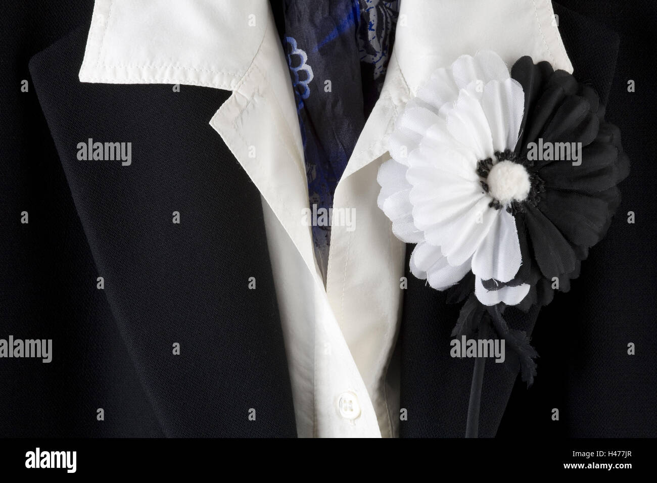 Black blazer, white blouse and black-and-white Ansteckblume, Stock Photo