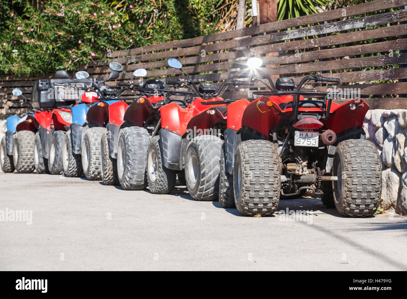 Zakynthos, Greece - August 14, 2016: Red and blue atv quad bikes stand parked in a row on roadside. Popular tourist mode of tran Stock Photo