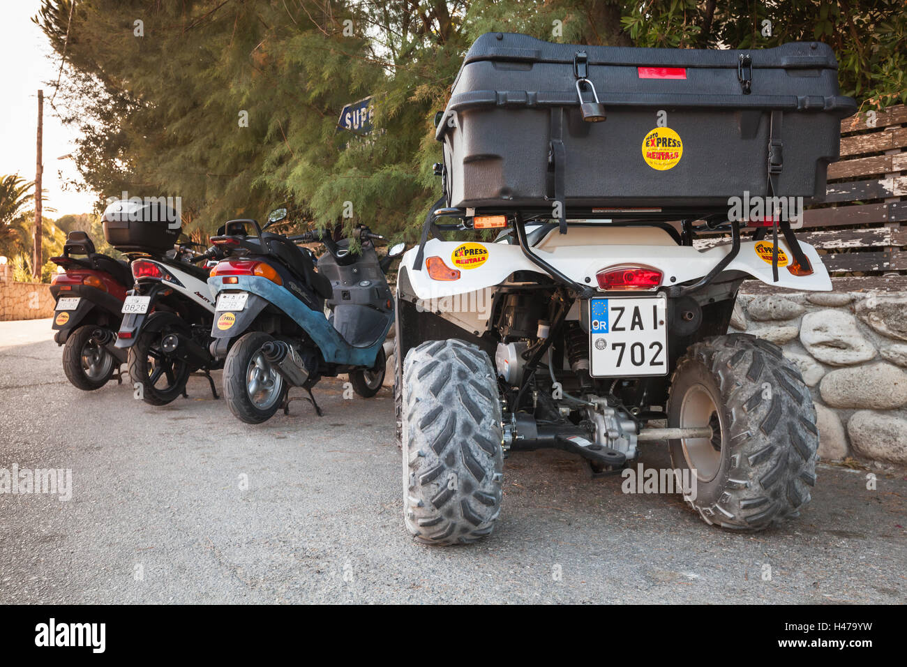 Zakynthos, Greece - August 16, 2016: ATV quad bike and scooters stand parked in a row on roadside. Popular tourist mode of trans Stock Photo