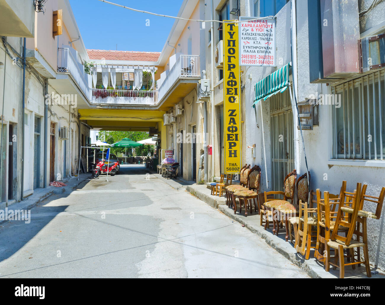 The wooden chairs stands on the street next to the closed cafe, Larnaca,  Cyprus Stock Photo - Alamy