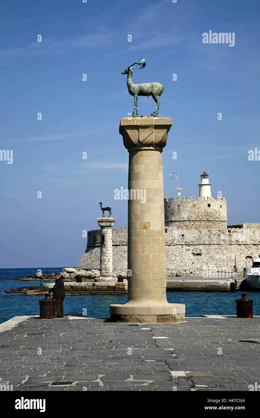 Greece, Dodekanes, island Rhodes, Rhodes town, Mandraki harbour, pillars, deer, agio Nikolaos tower, passer-by, town, island capital, Mandraki, harbour, port entrance, harbour mole, access road, heraldic animals, hind, tower, fortress attack, lighthouse, structures, historically, antique, place of interest, culture, person, tourist, summer, Stock Photo