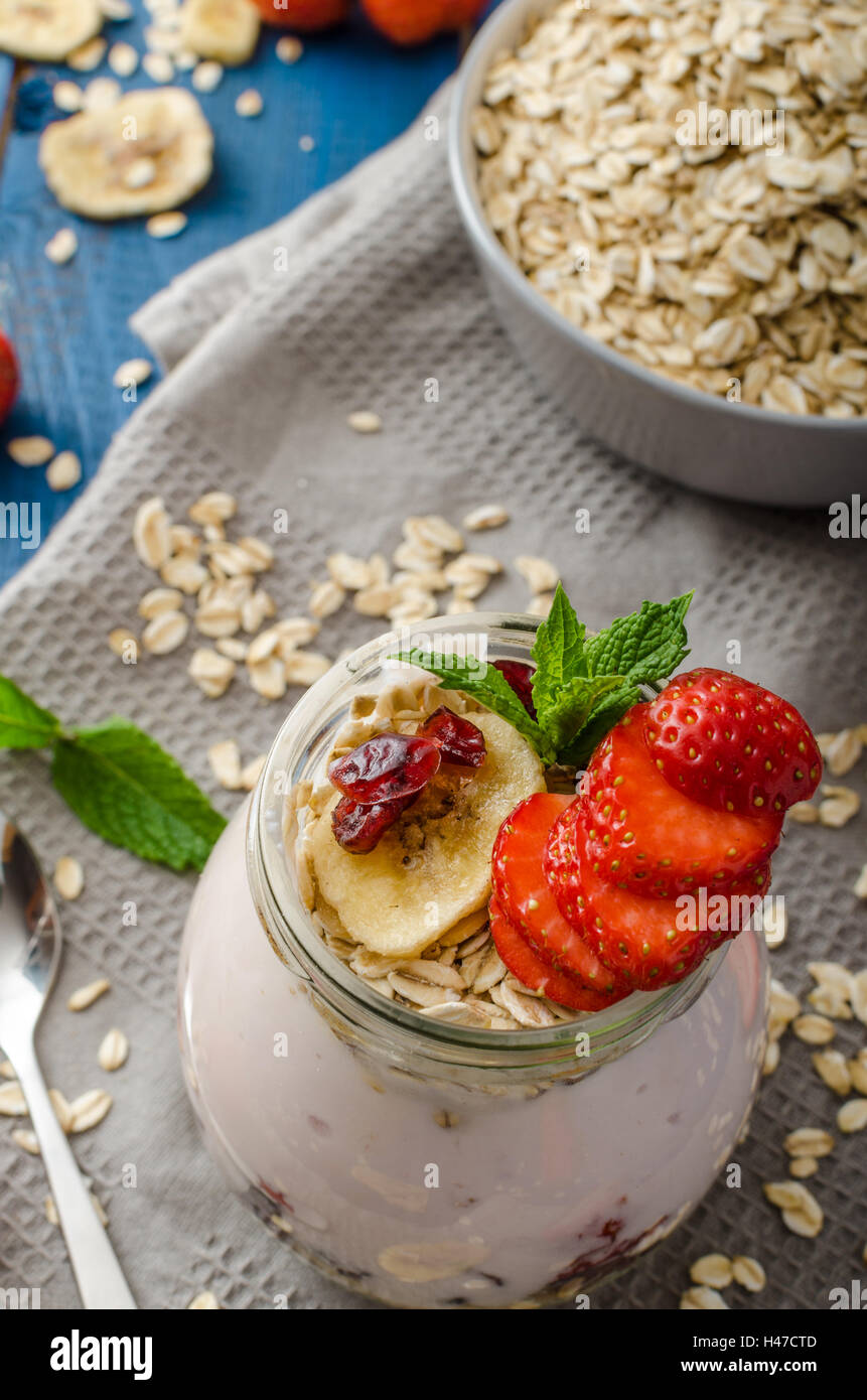 Domestic strawberry yogurt with granola and dried fruit, combination of fresh fruit and granola