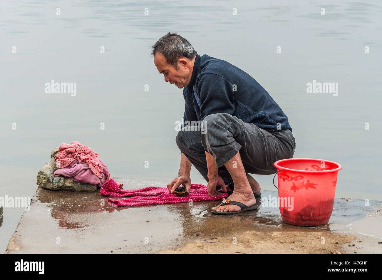 Village in China, in countryside, rural Asian farm. Chinese peasant man ...