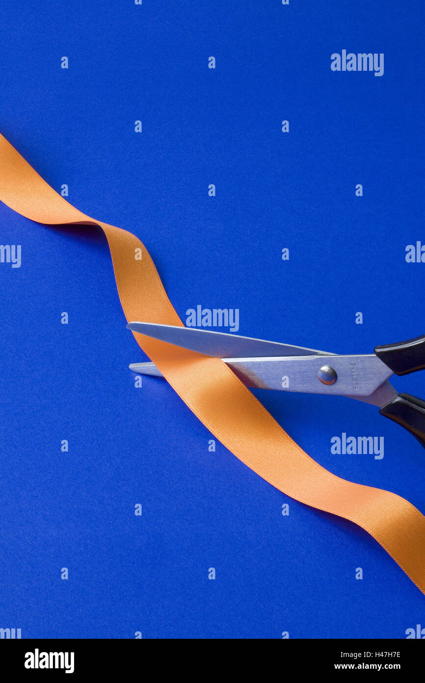 Scissors cutting textile tape, Stock Photo