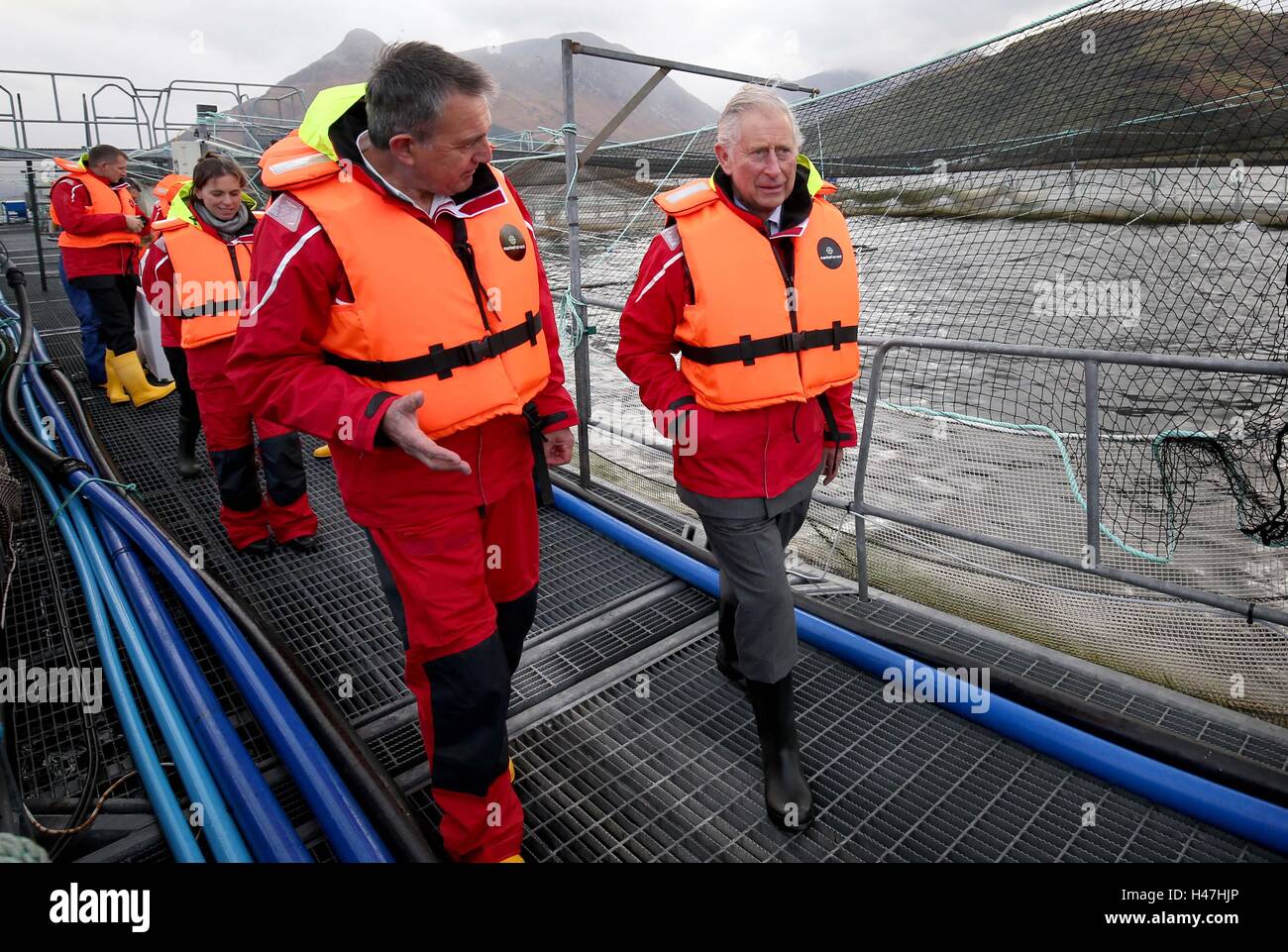 The Prince of Wales, known as the Duke of Rothesay while in Scotland, with Steve Bracken, Marine Harvest business support manager, during a visit to a sustainable salmon farm at Marine Harvest's Loch Leven Fish Farm, on Loch Leven at Onich, by Fort William, Inverness-shire. Stock Photo