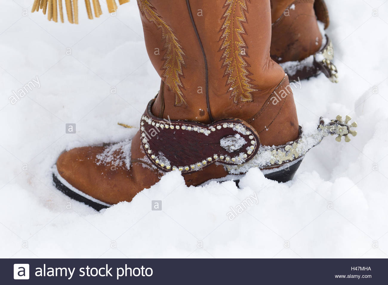 Cowboy boots with spurs in the snow 