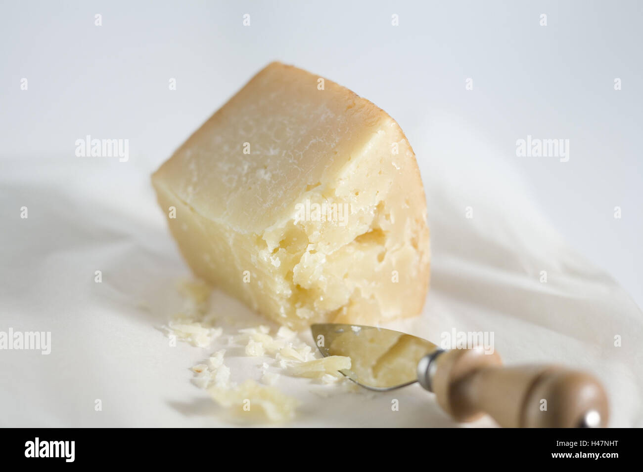 A piece parmesan cheese on paper, Stock Photo