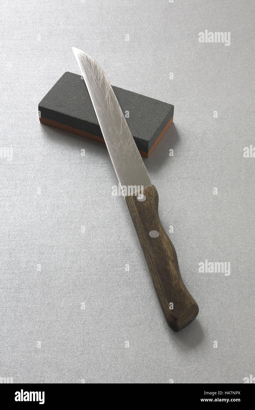 Knife on whetstone Stock Photo Alamy