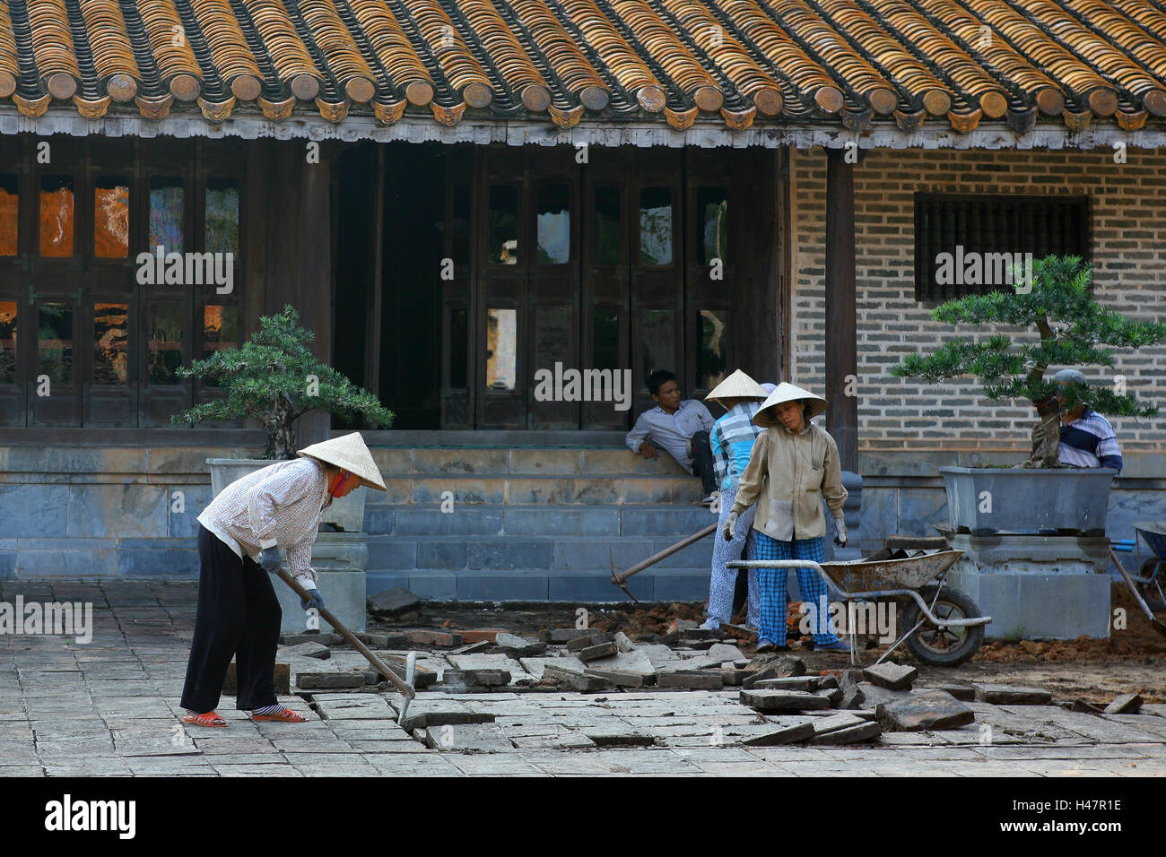Relaying paving slabs outside Hoa Khiem Palace, Tu Duc's mausoleum, Hue, Viet Nam Stock Photo