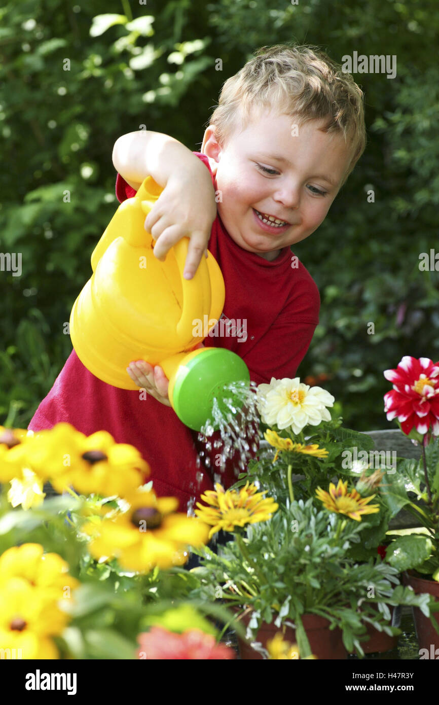 Little child, boy while watering flowers Stock Photo - Alamy