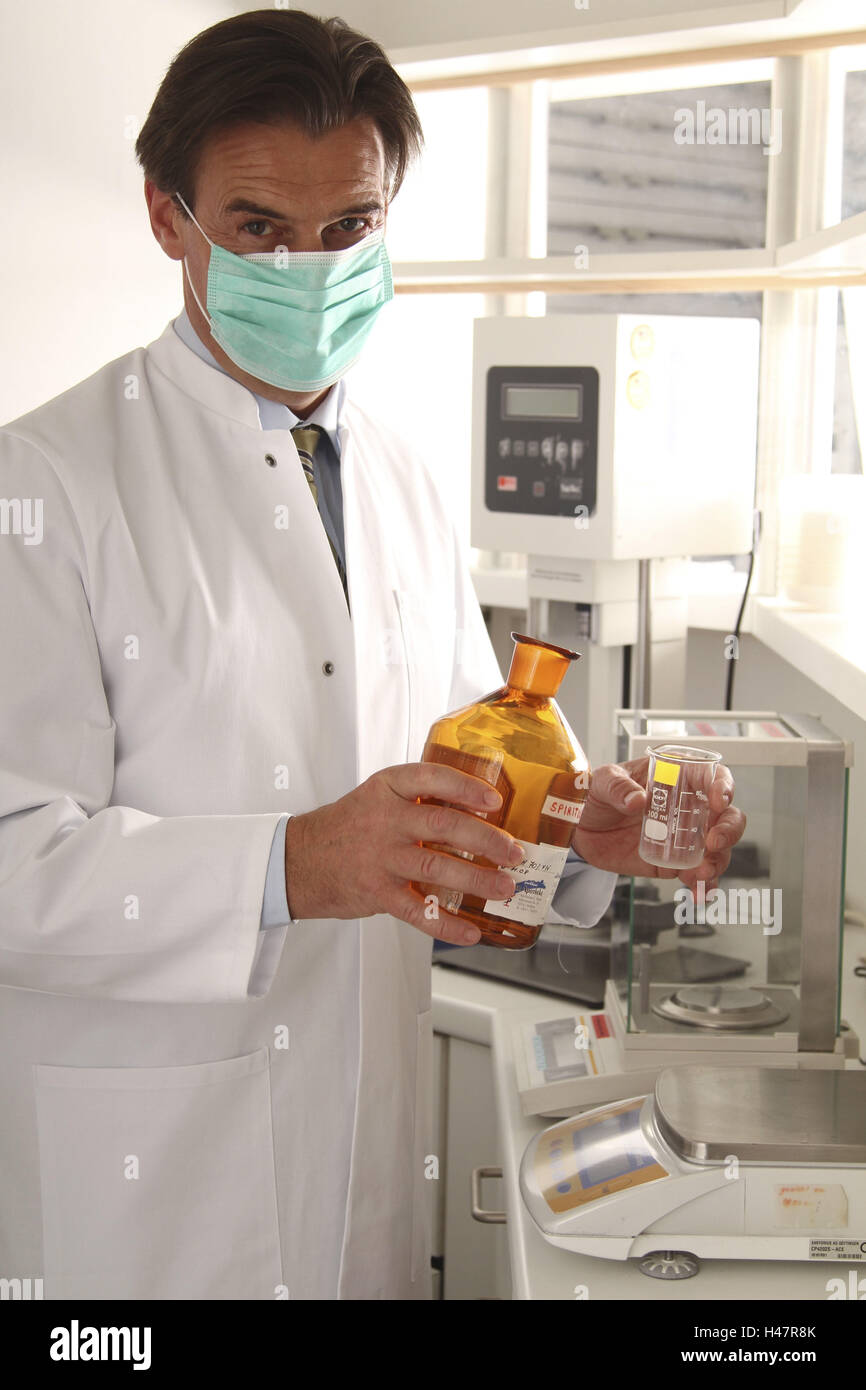 Pharmacist in the laboratory, pharmaceutical, mixing, producing Stock