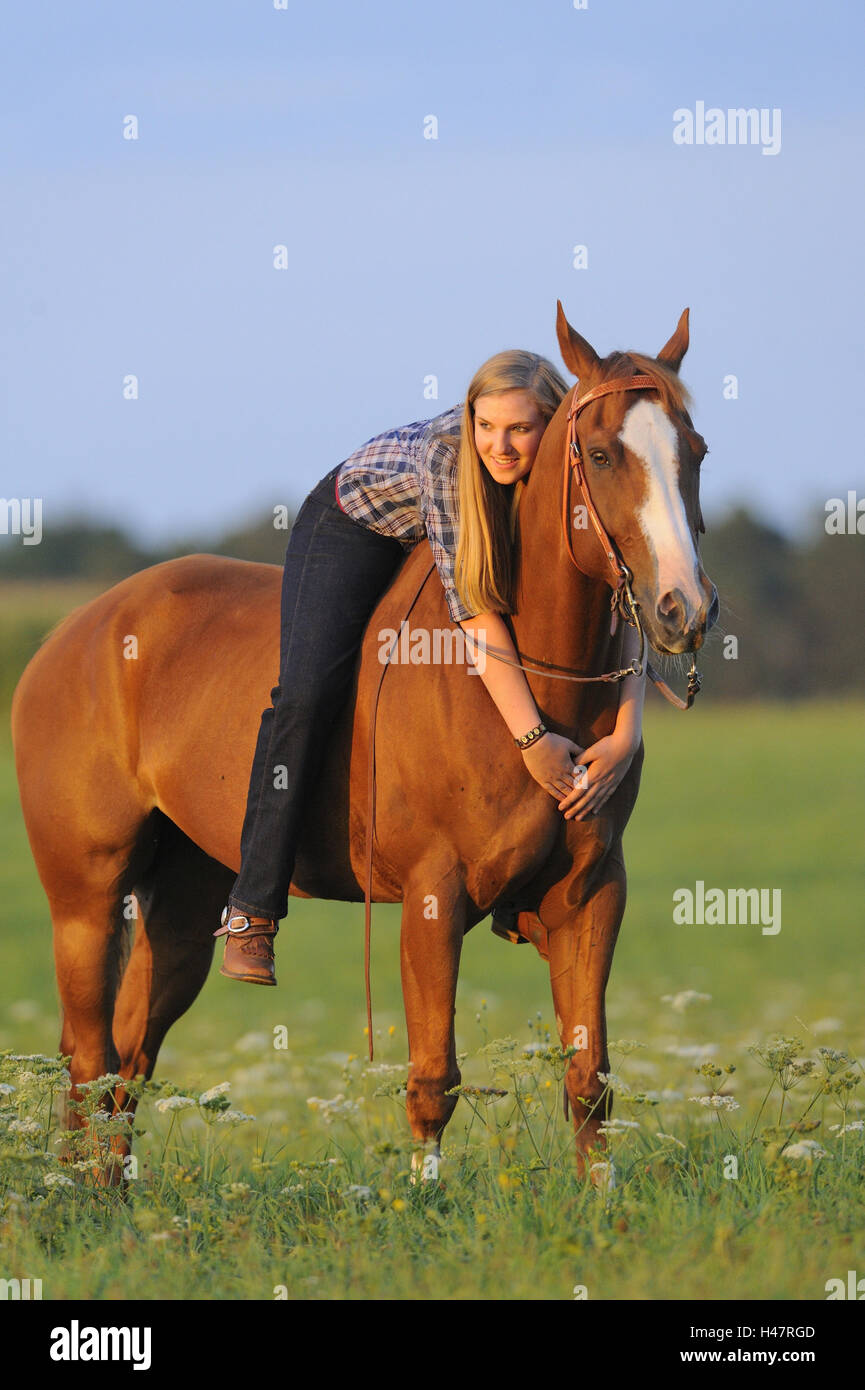 Teenage girl, horse, Paint Horse, back, lying, looking at camera, Stock Photo