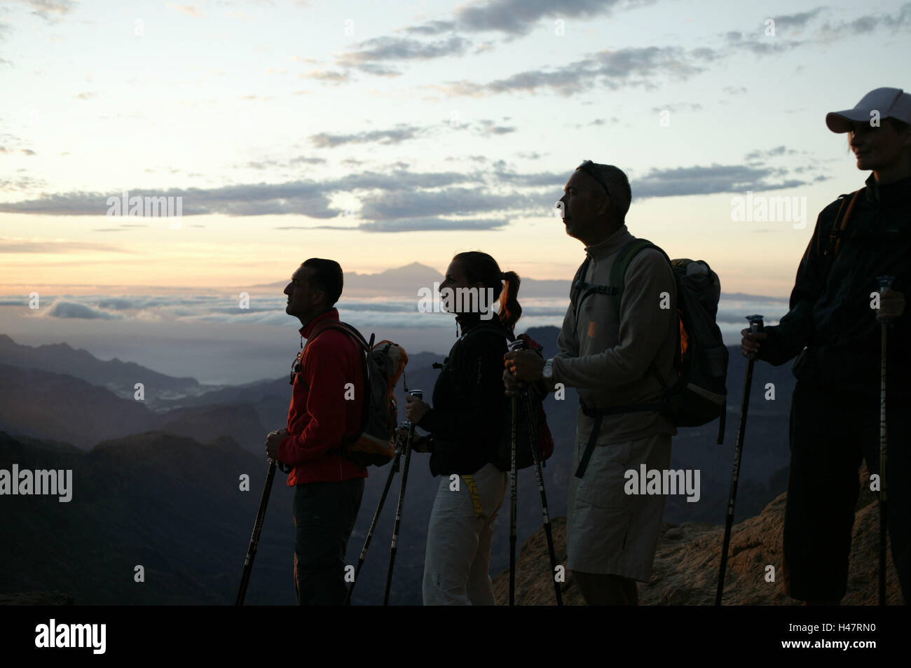 Traveling-group, standing, rocks, pause, traveling-equipment, mountain scenery, evening-mood Stock Photo