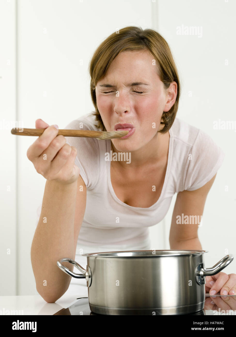 Woman, young, cook, cuisine, wooden spoon, season, inedible, saucepan Stock Photo