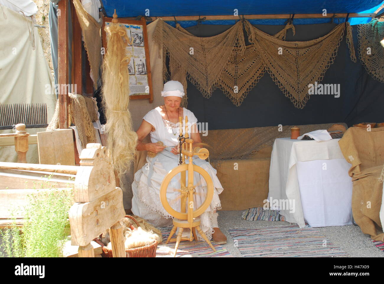 Medieval Spinning Wool Rack A woman in medieval dress spins wool Stock Photo - Alamy