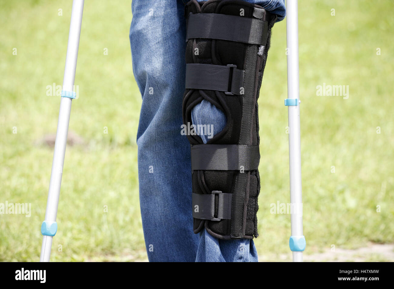 Person, detail, feet, knees, injury, crutches, rail, knee injury, trousers, jeans, bandage, knee prop, bone prop, black, accident, impediment, unwieldy, danger, insurance, encroachment, walking impediment, healing, accessory, person, Stock Photo