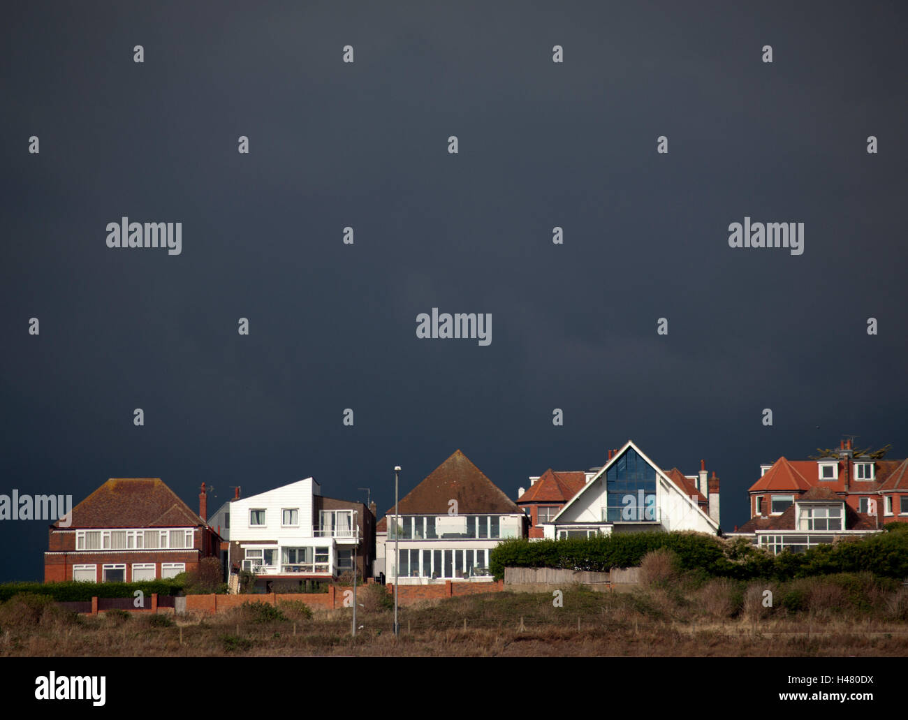 A dark sky frames houses high up on The Cliff in Brighton, BN2 Stock Photo