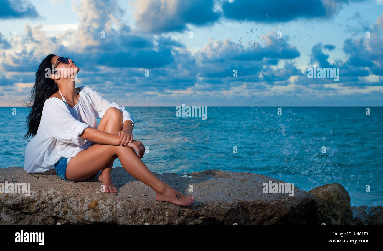Beautiful girl sitting on rock hi-res stock photography and images - Alamy