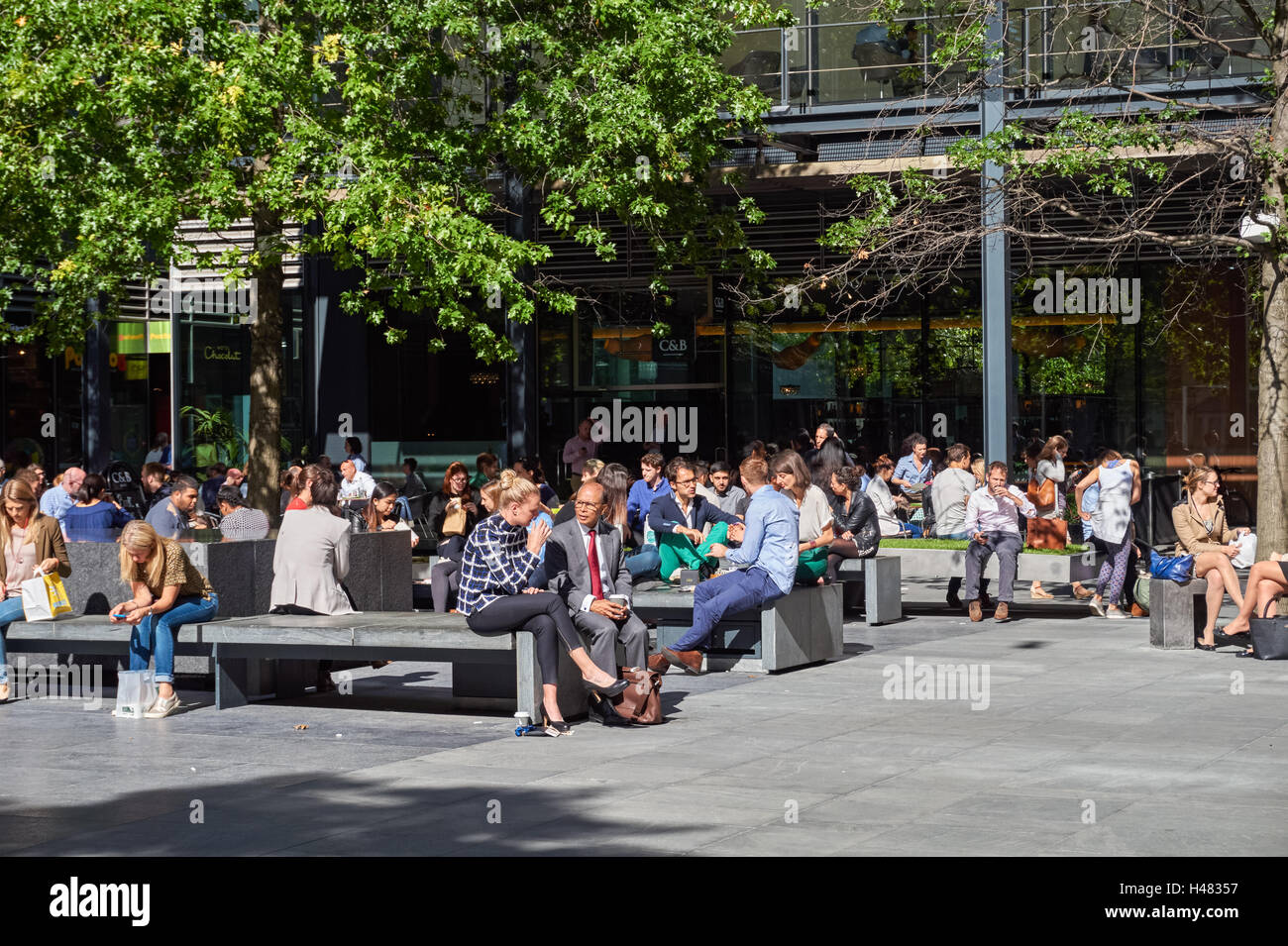 Office workers enjoying sunny weather at New Street Square in London, England United Kingdom UK Stock Photo