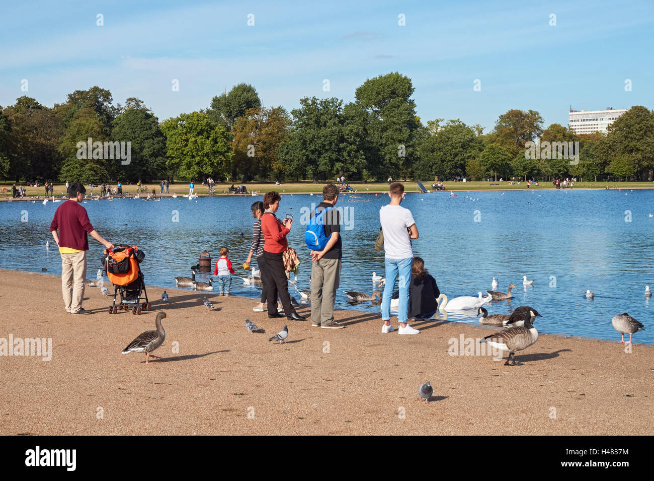 People enjoying warm September weather in Kensington Gardens, London