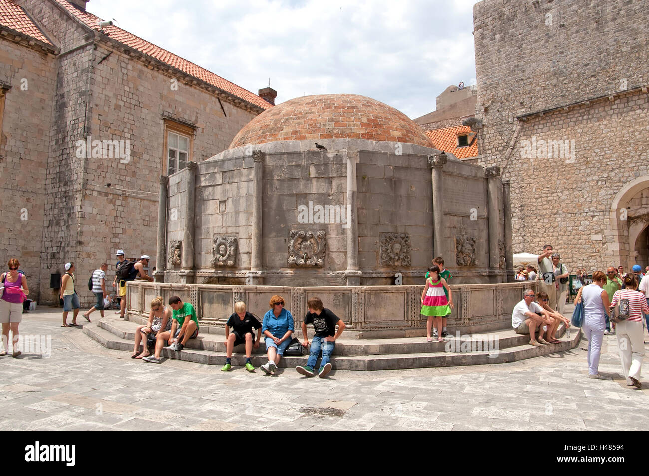 DUBROVNIK, CROATIA - JUNE 28, 2010: Unidentified tourists near the Big Fountain of Onofrio, one of the old town landmarks Stock Photo